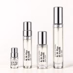 Four Fico di Amalfi decants with transparent labels and silver caps