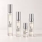 Four Green Irish Tweed decants with silver caps and transparent labels