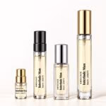 Four Amouage Interlude Man decants with transparent labels and black, gold and silver caps
