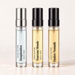 Louis Vuitton Trio: clear-labelled decants of Imagination, Nouveau Monde, Ombre Nomade on an off-white studio background.