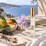 Gold-capped Millesime Imperial decant on a coastal ledge with citrus, iris, woods and sea salt